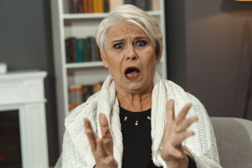 Old Lady Is Angry. Retired Caucasian Woman With Gray Hair Angry With Someone. She Emotionally Extended Her Arms And Opened Her Mouth In A Scream. Toned Image
свекровь