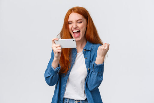 Confident and sassy good-looking redhead woman beat score, watching tennis match online on smartphone and cheering for player, fist pump delighted, celebrating success, winning in mobile game.
Везение, удача