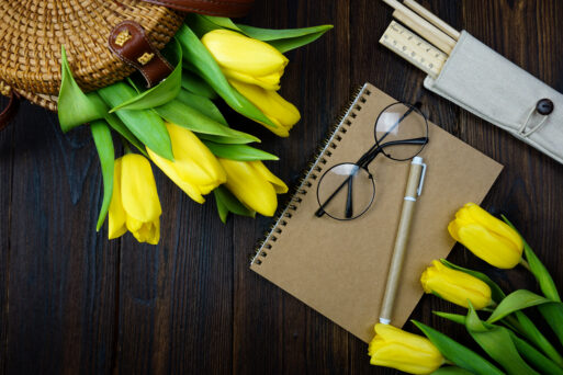 On the table there is a notebook for notes and beautiful yellow tulips. High quality photo.
Рабочая неделя